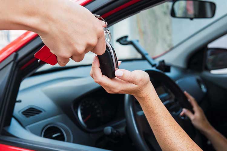 A customer getting their car keys handed to them